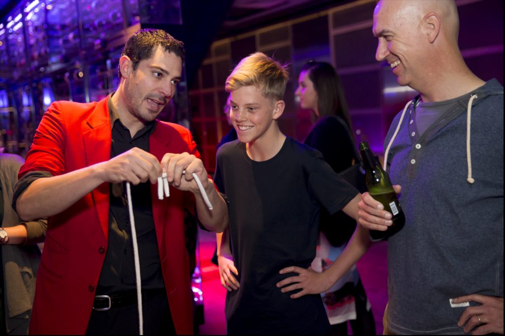 Roving Close Up Magic - Magician Sydney - Liam Power Sydney Magician performing roving close up magic at a corporate event